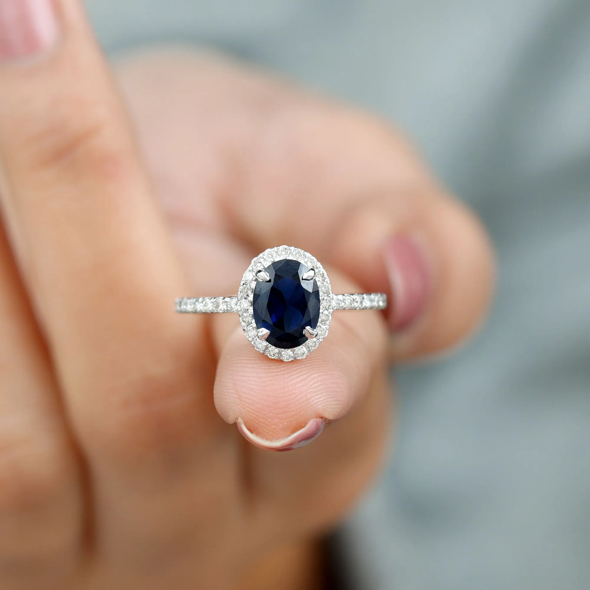 2 CT Oval Cut Lab Created Blue Sapphire Ring with Diamond Halo and Side Stones