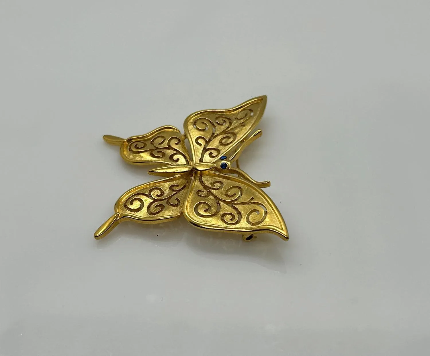 Crown Trifari Gold Tone Filigree Butterfly Brooch with Blue Eyes